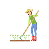 Woman Chopping The Ground Around Crops