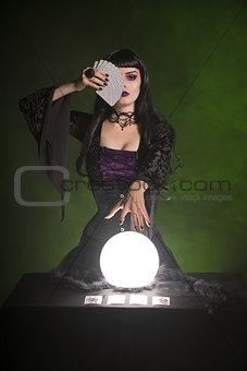 Fortune teller with playing cards and crystal ball 