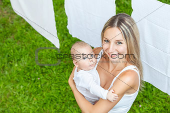 Beautiful mother and baby playing together outdoors