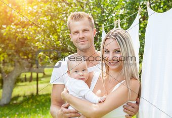 Happy family with a baby outdoors