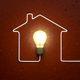 a light bulb building a house with the cable