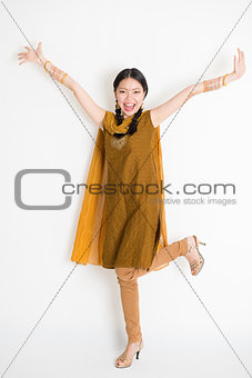 Excited Indian Chinese female arms raised