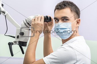 Dentist and a dental microscope