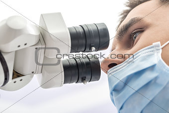 Doctor using a dental microscope