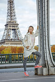 fit woman against Eiffel tower in Paris looking into distance