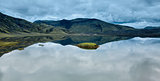 Lake coast with mountain reflection, Iceland