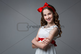 Teen girl with red bow on head