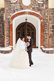 Wedding in winter. Newlyweds in the snowy park