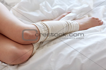 close up of young woman lying in bed at home