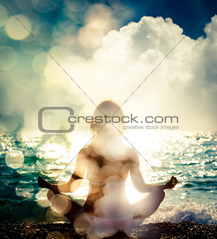 Woman Practicing Yoga by the Sea. Bokeh Background