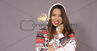 Pretty woman celebrating Christmas with fireworks