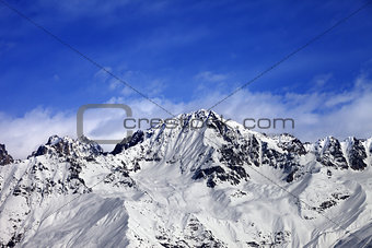 Snow mountains in winter sun day and blue sky with clouds