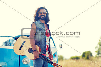 hippie man with guitar over minivan car outdoor