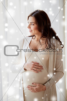 happy pregnant woman with big tummy at home