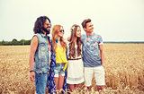 smiling young hippie friends on cereal field