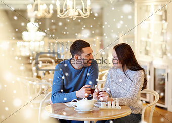happy couple drinking tea at cafe