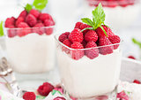 Delicious sweet  mousse decorated with fresh raspberries
