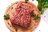 minced meat on a wooden cutting board