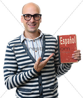 handsome guy holds a textbook. learning spanish concept