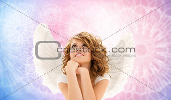 happy young woman or teen girl with angel wings