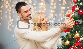 happy couple decorating christmas tree