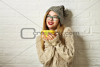 Smiling Hipster Girl in Winter Clothes with a Mug
