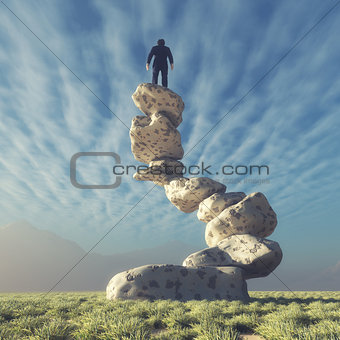 Silhouette of a man on top of rocks 