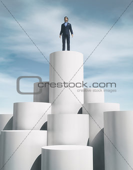 Man stand up on a cylinder.