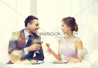 couple with main course and red wine at restaurant