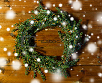 natural green fir branch wreath on wooden board