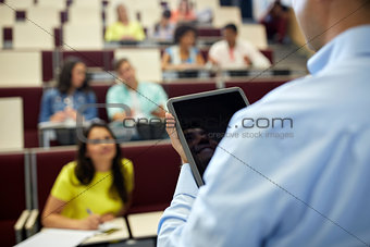 teacher with tablet pc and students at lecture