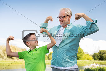 happy grandfather and grandson showing muscles