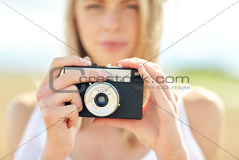 close up of woman photographing with film camera