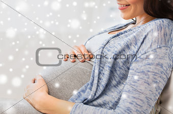 close up of happy pregnant woman at home