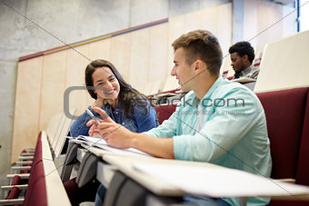 group of students with notebooks at lecture hall
