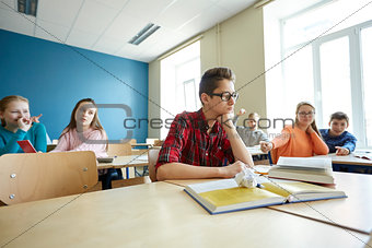classmates laughing at student boy in school
