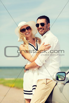 happy man and woman hugging near car at sea