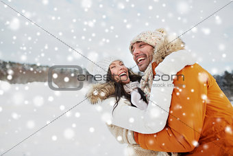 happy couple hugging outdoors in winter