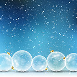 Christmas baubles on snowy background 