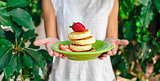 Sweet ricotta pancakes in woman hands