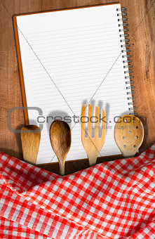Kitchen Utensils on Wooden Table with Notebook