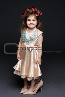 Cute little girl in dress and high heels