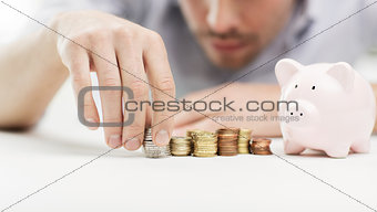 close up of businessman with piggy bank and coins