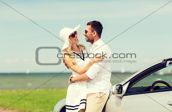 happy man and woman hugging near car at sea