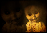 Grunge background with vintage evil spooky doll with zipped mout