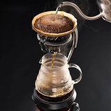 Brewing coffee with black background, close up