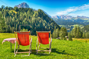 deck chairs and table on the meadow