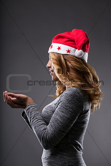 Chrismas costume on a girl holding a placeholder (side perspecti