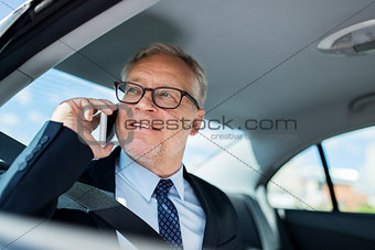 senior businessman calling on smartphone in car