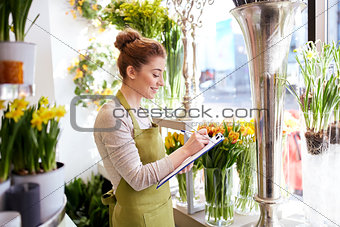 florist woman with clipboard at flower shop